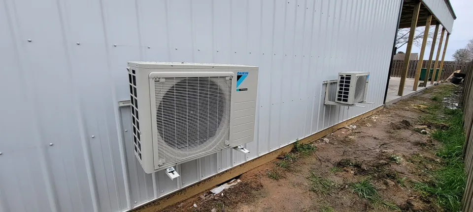 Two outdoor ductless units beside a metal building in the S&S work portfolio